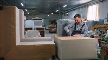 Worker Assembling Sofa Frame in Upholstery Workshop video