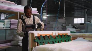 Upholstery Worker Securing Padding to Sofa Frame video
