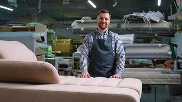 Smiling Upholsterer Standing by Finished Sofa in Workshop video