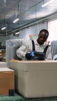 Worker Attaching Fabric to Sofa Base in Workshop video