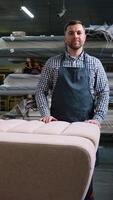 Smiling Upholsterer Standing by Finished Sofa in Workshop video