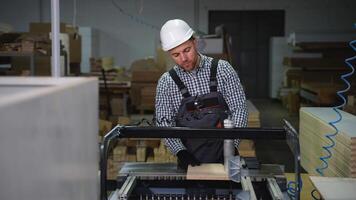 Man Operating Drilling Machine in Wood Workshop video
