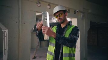 Busy Caucasian architect male engineer handyman man builder repairing metal detail iron fittings in construction professional workman guy repairman using tool instrument job factory production build video