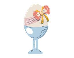 Decorative egg with a colorful bow placed in an elegant egg cup for a festive celebration vector
