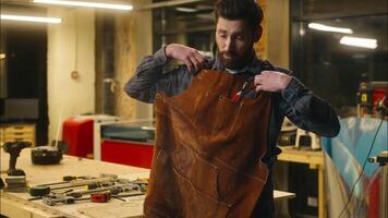 Caucasian man wood master handyman guy craftsman finish workday artist employee clean hands carpenter male removing apron workwear in workshop workman builder turning off light end working carpentry video