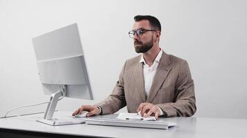 Focused Business man inspired by an idea typing on a computer keyboard in a bright modern office. The concept of comfortable and successful work. Free copy space, white background video