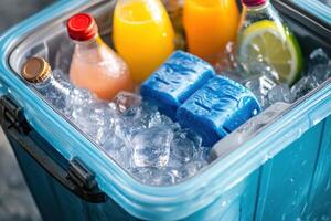 A blue cooler filled with ice and drinks including orange juice, lemonade photo