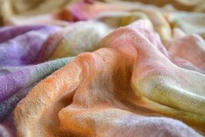 A colorful piece of fabric with a variety of colors and textures photo