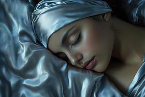 A woman is sleeping on a bed with a blue blanket photo