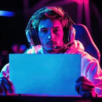 A man wearing headphones is holding a blank sheet of paper photo