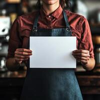 A woman is holding a white piece of paper in front of her photo