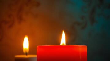 Two red candles are lit in front of a dark background photo