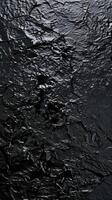 A black surface with water and ice photo