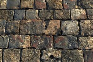 A stone wall with many different colors and patterns photo