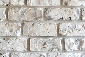 A wall made of white bricks with some paint on it photo