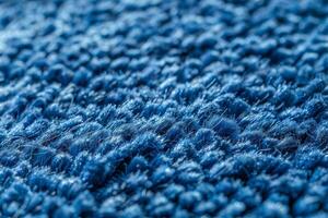 Closeup of a blue carpet with a fuzzy texture photo