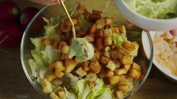 Using a spoon, the chef carefully adds avocado guacamole to the shrimp salad. Close up. video