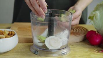 Sliced avocado is added to boiled eggs in a blender, where it is mixed to create a smooth, puree-like consistency. video