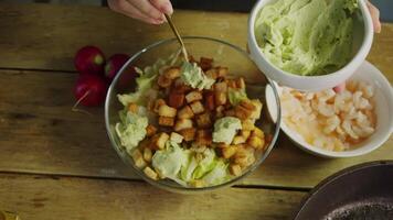 Delightful salad, featuring delectable combination of fried shrimp and seafood croutons, is enhanced with a touch of fresh green avocado puree. video