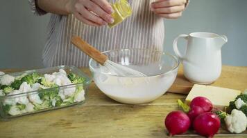 A cream sauce, based on sour cream and a variety of Provencal herbs, is mixed with a whisk in the restaurant's kitchen, along with the vegetables. video
