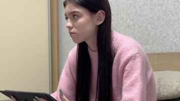 Young woman using digital tablet at home video