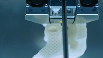 Modern 3D printer printing figure close-up macro.Automatic three dimensional 3d printer performs plastic white color modeling in laboratory. 3d-printing processing with white background 10 video