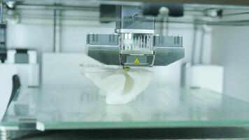 Modern 3D printer printing figure close-up macro.Automatic three dimensional 3d printer performs plastic white color modeling in laboratory. 3d-printing processing with white background 3 video