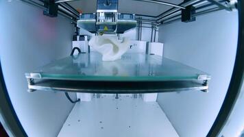 Modern 3D printer printing figure close-up macro.Automatic three dimensional 3d printer performs plastic white color modeling in laboratory. 3d-printing processing with white background video