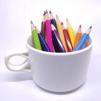 A pencil standing in a white cup, simple and minimalistic, with a clean and classic look. photo