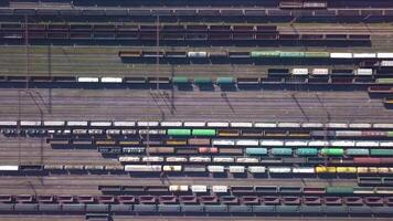 Aerial view of Railway sorting station and A lot of wagons at a railway. Drone flies over railway tracks. 4k quality video