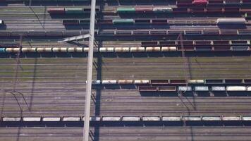 Aerial view of Railway sorting station and A lot of wagons at a railway. Drone flies over railway tracks. 4k quality video