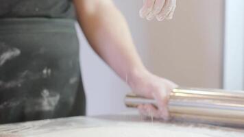 Italian pizza chef forming the dough on a floured surface and rolling out a dough 5 video
