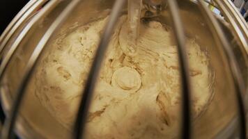 Close-up of dough mixing in a professional kneader machine in kitchen of bakery or at the manufacturing. Stock footage. Dough making process 4 video