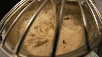 Close-up of dough mixing in a professional kneader machine in kitchen of bakery or at the manufacturing. Stock footage. Dough making process 3 video