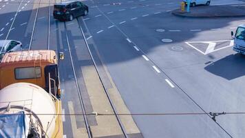 A timelapse of tram and vehicle at the gingko tree crossing panning video