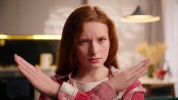 Confident frown girl female stop gesture angry Caucasian woman say no crossed hands crossing arms not limit warning finish gesture prohibit access declining body language danger prevent at home couch video
