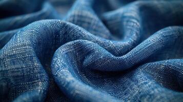 Close-up view of a vibrant blue textile with intricate woven patterns and soft folds. photo