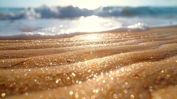Close-up of wet golden sand on a beach, sunlit waves in the background. photo