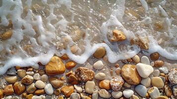 Close-up view of foamy waves lapping over a beach with colorful pebbles. photo