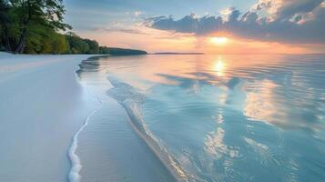 Serene sunrise over tranquil beach. Soft waves lapping at pristine white sand, mirrored in calm azure water. Lush green trees line the shoreline. Vibrant sunrise sky with clouds. photo
