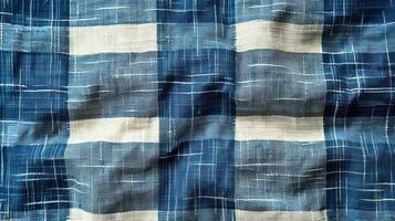 Close-up of a textured fabric with a blue and white gingham pattern. Wrinkled and slightly creased, showing the weave. photo