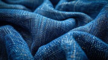 Close-up of deep blue textured fabric, showing folds and weave patterns. photo