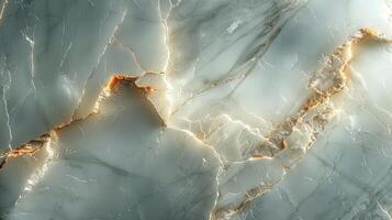 Detailed close-up view of a light gray and white marble surface with golden veins, showing textured cracks and patterns. photo