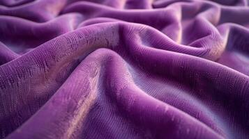 Close-up view of draped, textured, deep purple fabric with subtle light and shadow patterns. photo
