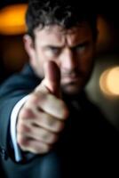 Businessman in Dark Suit Giving Thumbs Down Gesture photo