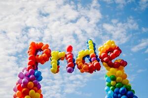 Pride balloons floating in the sky photo
