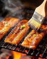 Freshly Grilled Eel Drizzled with Tare Sauce on a Charcoal Grill Enveloped in Tantalizing Smoke photo