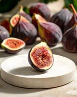 Fresh ripe figs displayed on a round podium photo