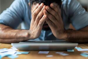 Unemployed Person Searching for Job Opportunities Online Amid Financial Stress and Uncertainty photo
