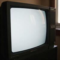 An old TV with a plain white blank screen photo